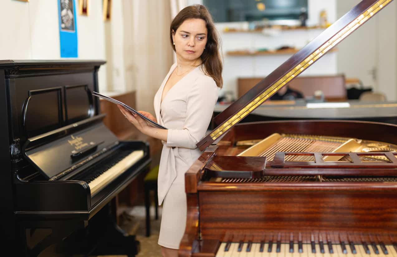 Woman shopping for used piano at piano store