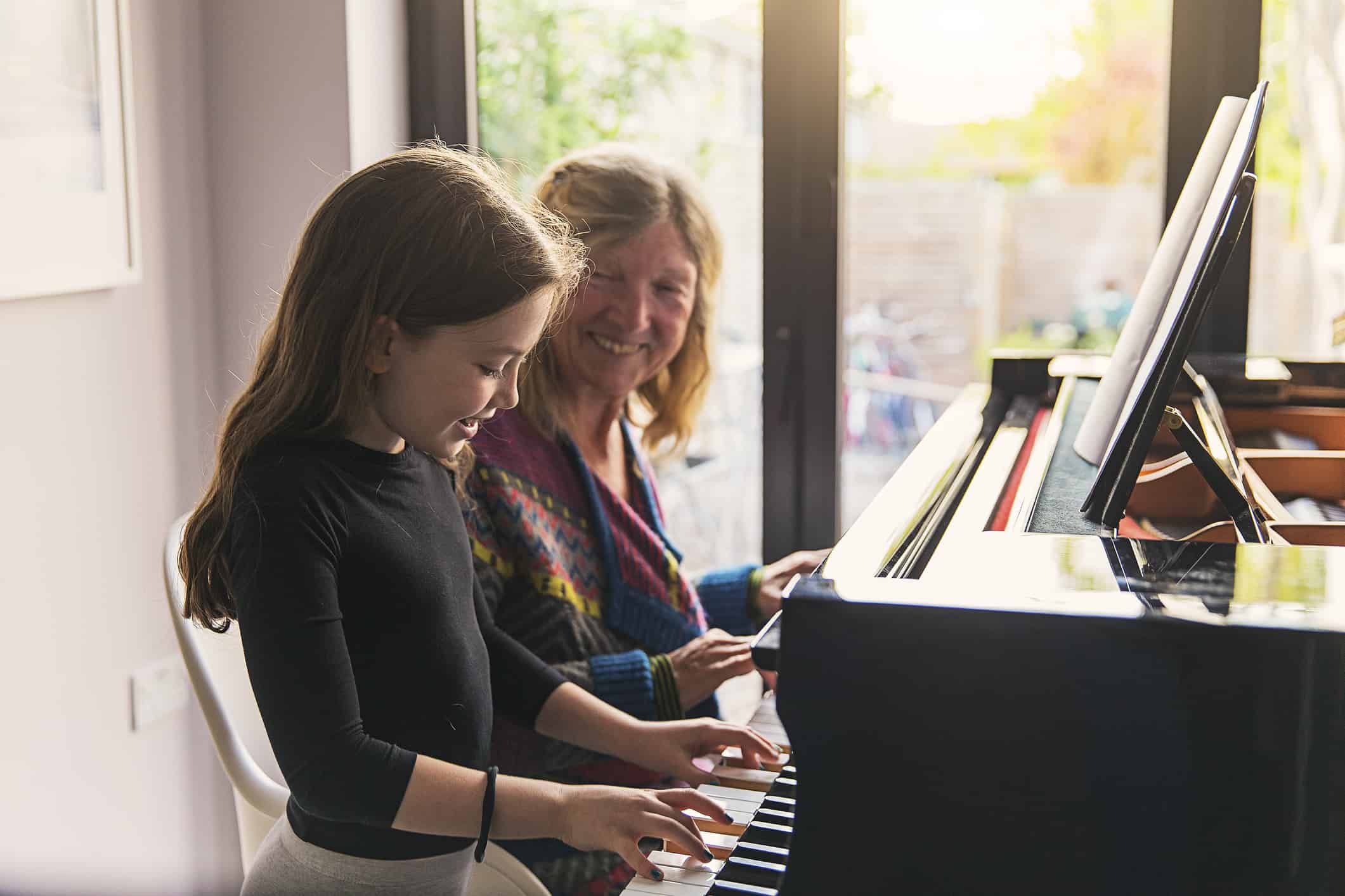 Young girl on beginner piano learning to play