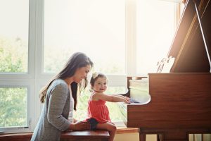 Toddler Playing Piano in Home