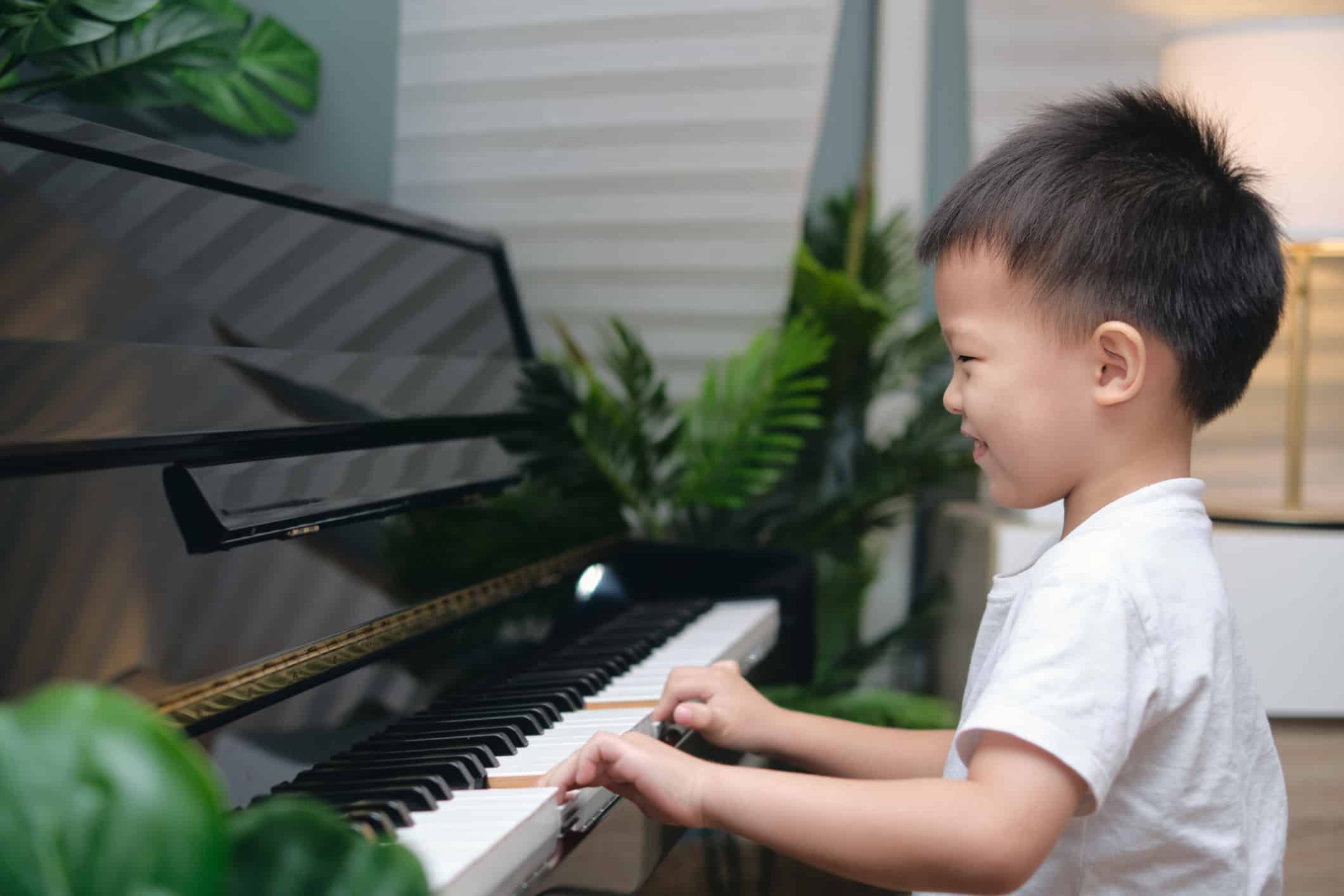 Young boy playing Yamaha U3 upright piano