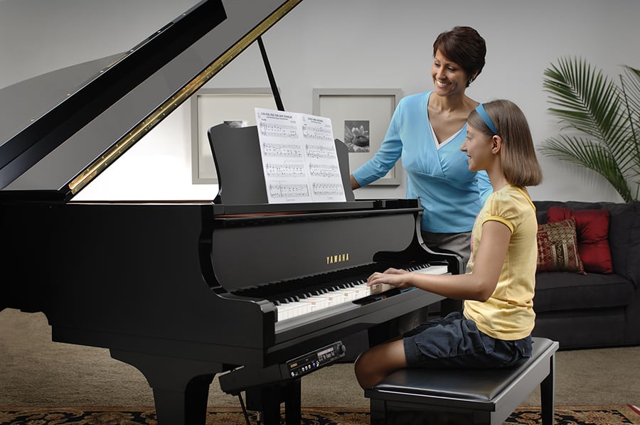 Disklavier for Education Woman and girl during piano lesson